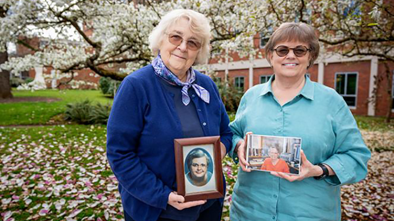 Anne Laskaya (left) and Linda Long (right) are holding photographs of their late wives.