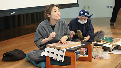Visiting Japanese artists demonstrate the woodblock printmaking technique known as nōsatsu. 