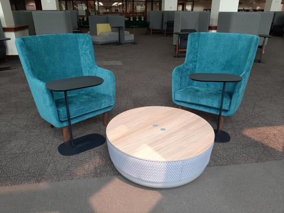 Two blue high-backed chairs with white circular table