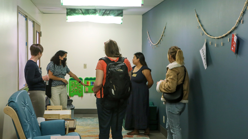 Five people view the new ABC 123 Room in Knight Library during the opening event on September 21. Organizers Kate Smith (far left in black top) and Hana Chan (second from right in dark blue dress) are included in this group photo.