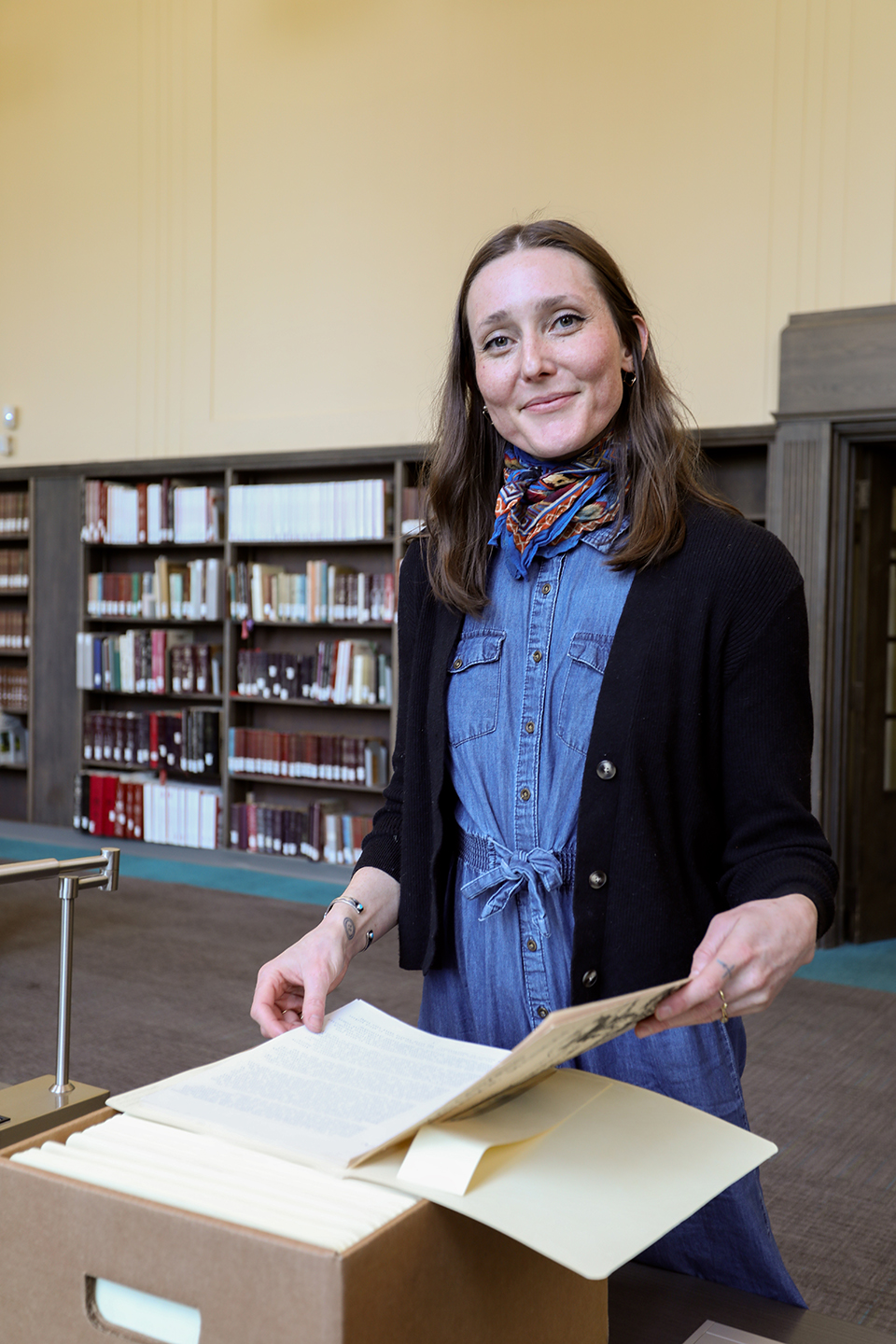 Emily Moore examining collection materials in a banker's box.
