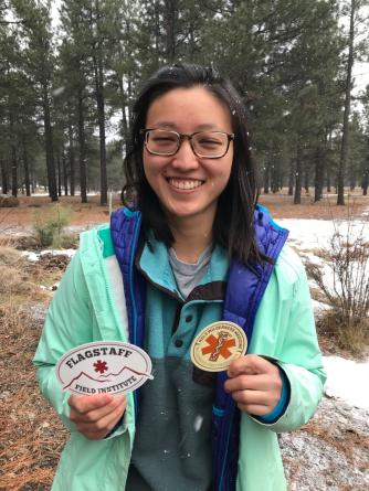 ​Hannah Gershone holds stickers from the Flagstaff Institute.