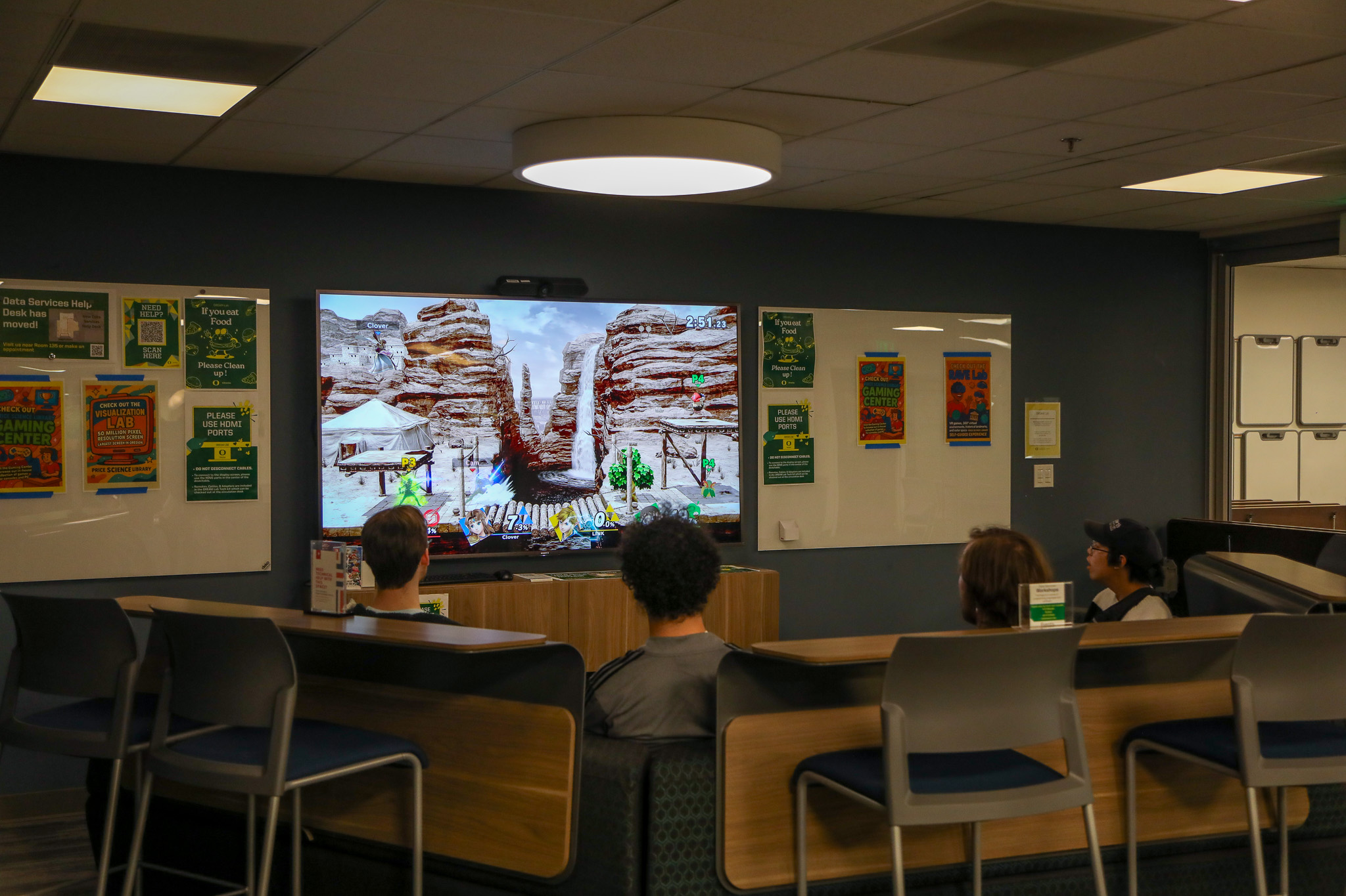 Group of students playing Super Smash Bros on a DREAM Lab screen.