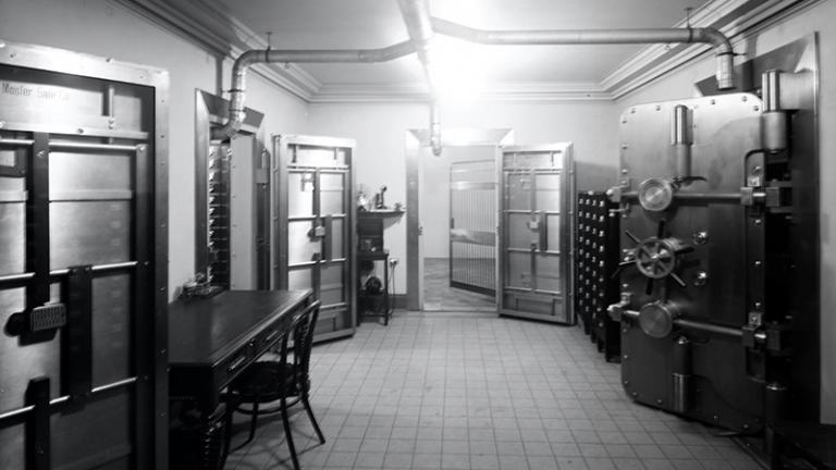 Black and white photograph of open bank vaults