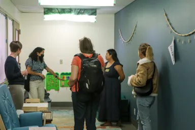 Visitors view the new ABC 123 Room in Knight Library during the opening event in September 2023, including organizers Kate Smith (far left) and Hana Chan (second from right).