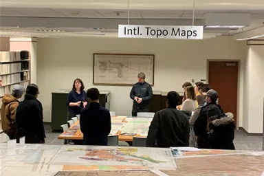 Librarian Kathy Stroud provides instruction about maps to UO students in Knight Library.