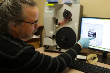 ODNP Project Manager Justin Spence operating a digital microfilm scanning machine.