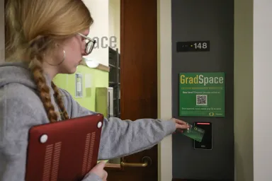 Student using card reader for GradSpace