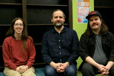 Eowyn Boosinger, Jimmy Murray, and James Daley sitting in the Grad Space 