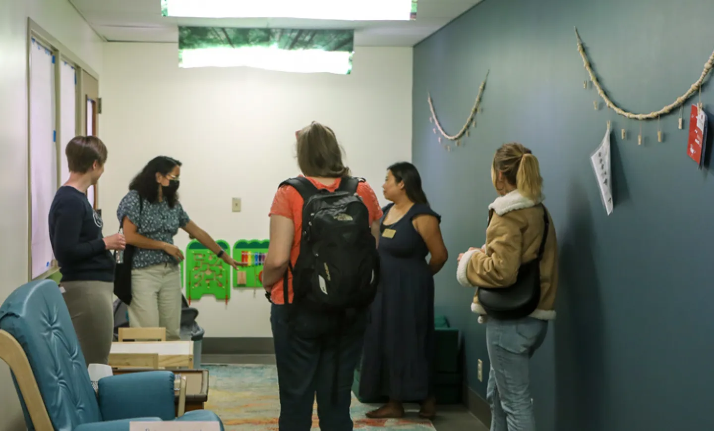 Visitors view the new ABC 123 Room in Knight Library during the opening event in September 2023, including organizers Kate Smith (far left) and Hana Chan (second from right).