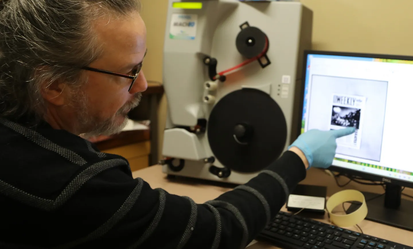ODNP Project Manager Justin Spence operating a digital microfilm scanning machine.