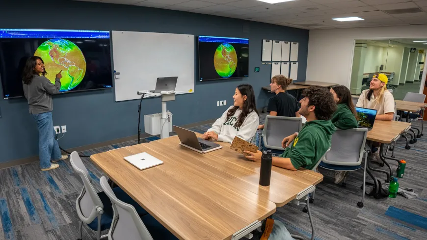 Students around tables in a classroom