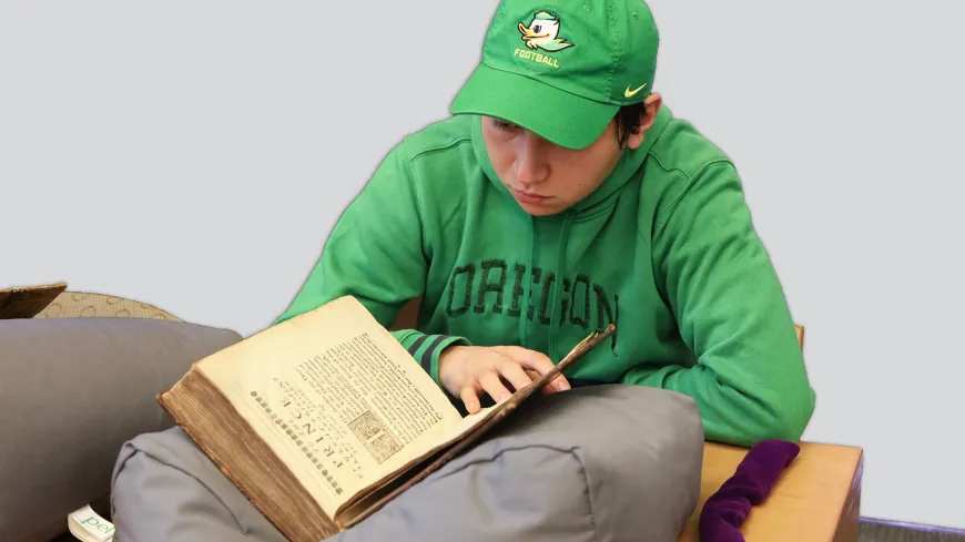 Person wearing green looking at manuscript