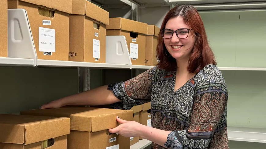 woman taking a box off of a shelf