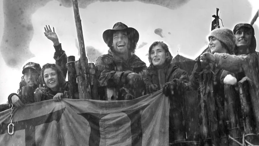 Snow falls on a group of men and women activists at the Warner Creek logging road blockade.