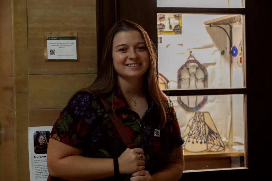 Kacey Drake standing outside her Tiny Gallery exhibit.