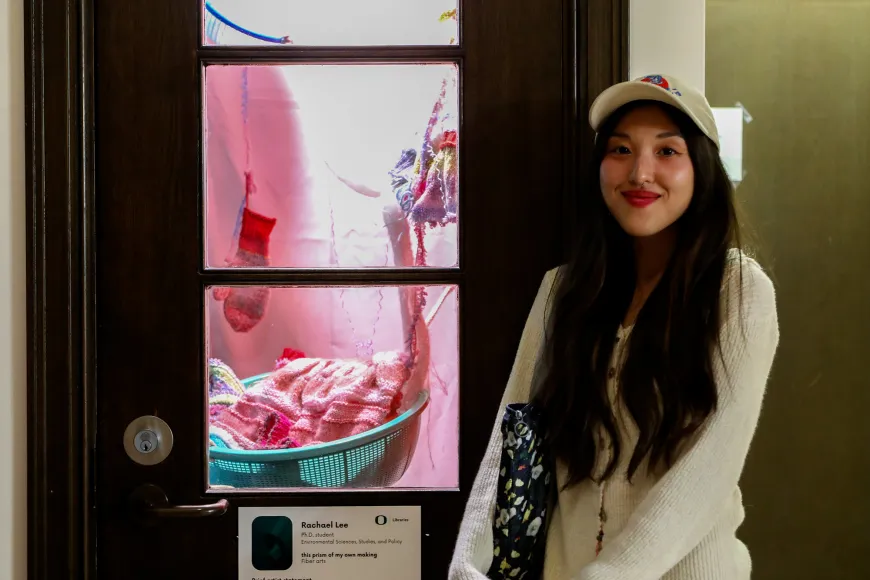 Rachel Sol Lee standing next to her Tiny Gallery exhibit.