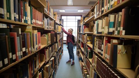 A student in the stacks of the library