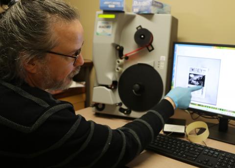 ODNP Project Manager Justin Spence operating a digital microfilm scanning machine.