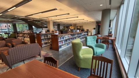 Library seating, study tables, and blue and green lounge seating