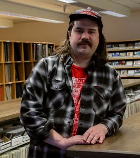 James Daley, research and learning spaces assistant, standing in the Douglass Room