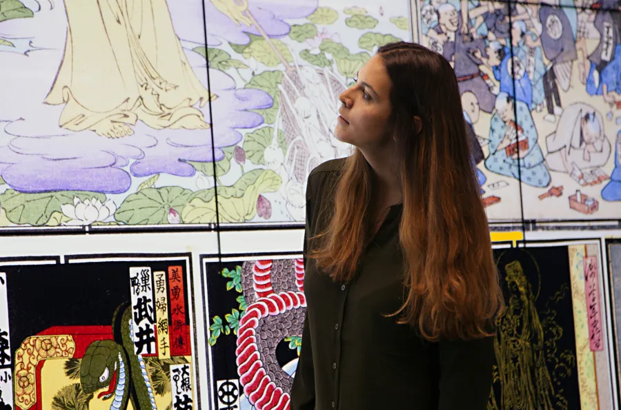 A woman looking at artwork on a large digital screen