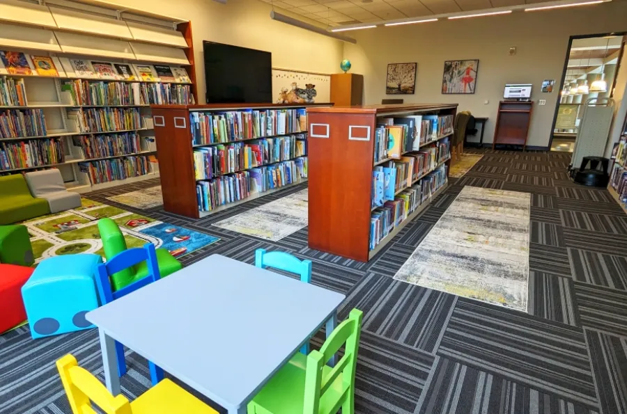 Portland Library room 201 displaying children&#039;s seating, books on shelves, and artwork