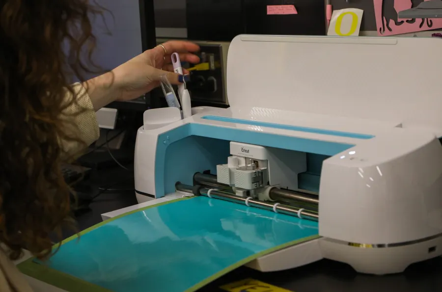 Person operating a Cricut Maker device