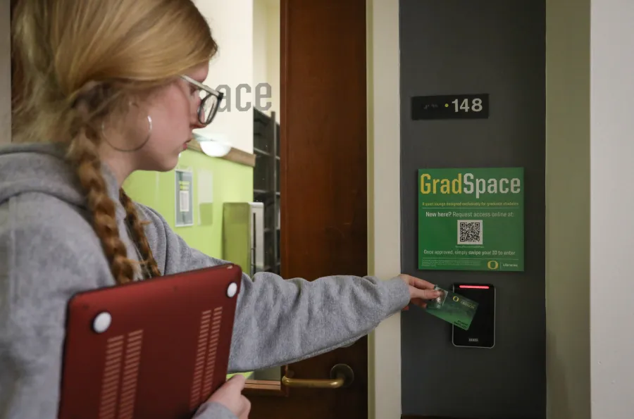 Student using card reader for GradSpace