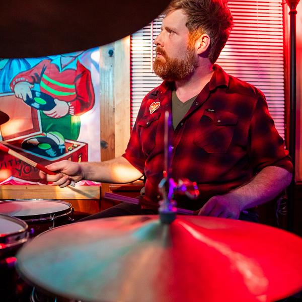 Library cataloger Mitch Hughey playing drums.