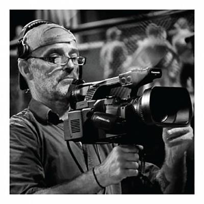Tim Lewis operating a video camera.