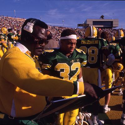 A coach and players at University of Oregon football game