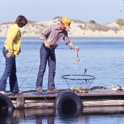 Two people on a dock crabbing